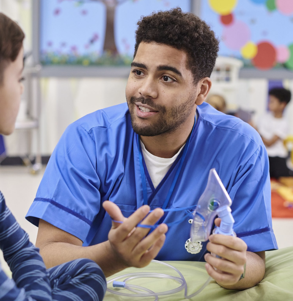 male doctor showing child patient a breath test device