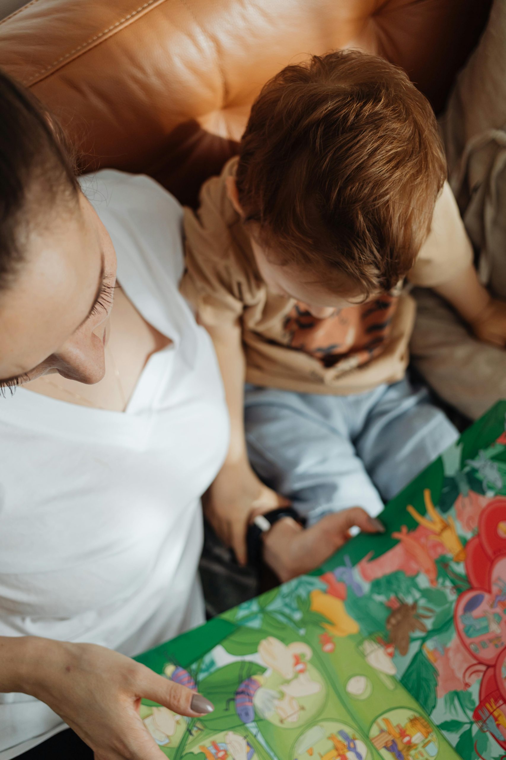 mum reading a book with her young son