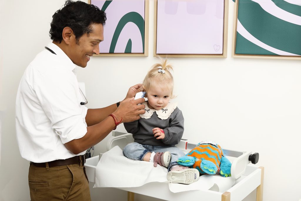 paediatrician checking baby's ear